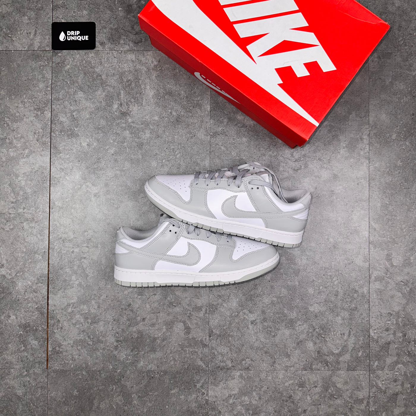 Men's Nike Dunk Low in a Grey Fog colourway showing the side design, dripuniqueuk